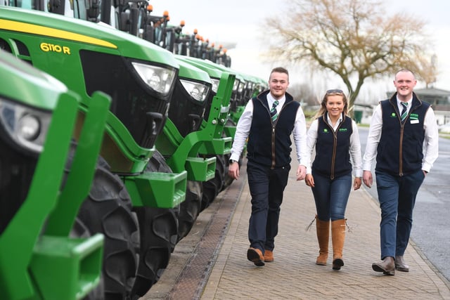 Picture: Ripon Farm Services staff take a moment to admire the tractors on sale.