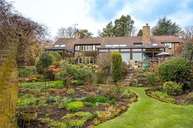Beautiful landscaped gardens are to the rear of this unusual village home.