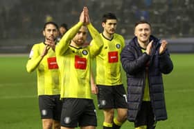 Harrogate Town players celebrate Saturday's 1-0 League Two victory at Carlisle United with their travelling fans. Pictures: Matt Kirkham