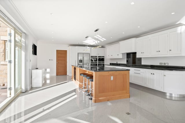 The bespoke kitchen with island unit and breakfast bar.