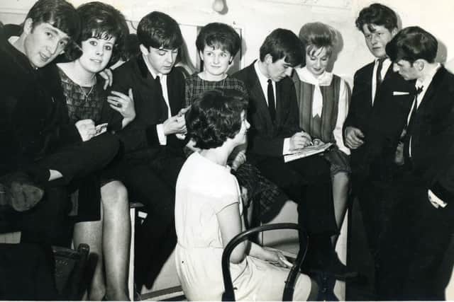 March 8, 1963 - The Beatles in the dressing room at Harrogate's Royal Hall signing autographs for fans. (Picture Terry Mason)