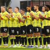 Harrogate Town players join in a minute's applause held in memory of Sulphurites supporter Johnny Walker before Saturday's League Two clash with Mansfield Town. Picture: Matt Kirkham