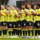 Harrogate Town players join in a minute's applause held in memory of Sulphurites supporter Johnny Walker before Saturday's League Two clash with Mansfield Town. Picture: Matt Kirkham