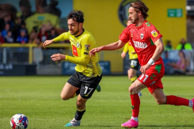 Levi Sutton's last-gasp goal earned Harrogate Town a 2-2 draw against AFC Wimbledon on Good Friday.