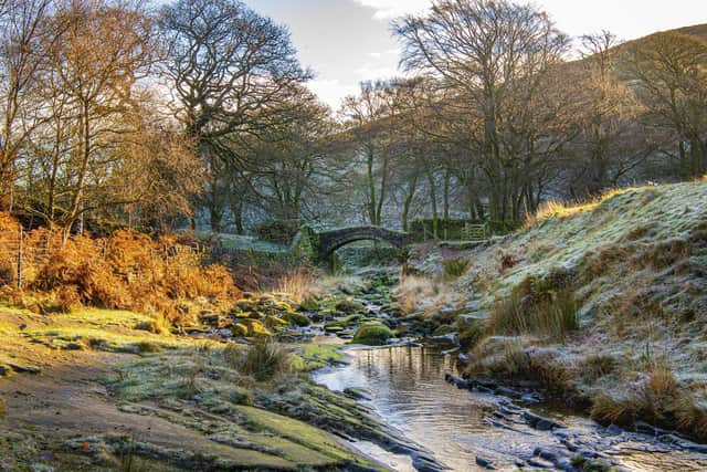 The picturesque Easter Gate Bridge, also known as Close Gate Bridge, an ancient packhorse bridge on the Marsden Moor Estate close to Standedge Tunnel shot on a cold frosty morning.