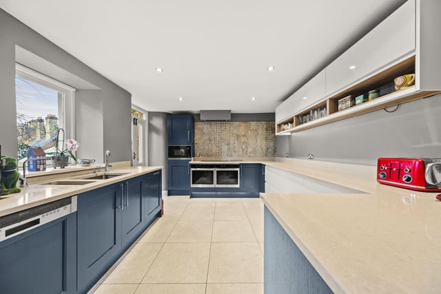 A large and modern kitchen, with silestone worktops and Miele integrated appliances.
