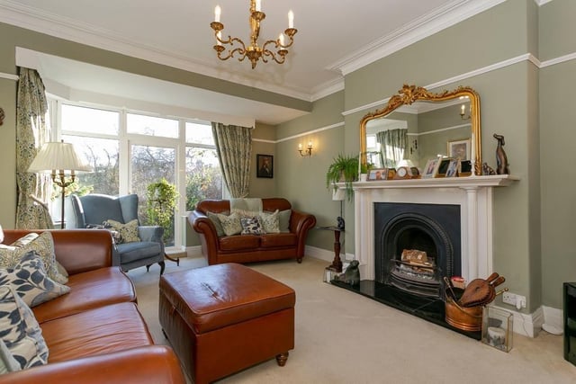 This spacious sitting room, with feature open fireplace, leads through to a snug with a multi-fuel burner, and original Edwardian cupboards.