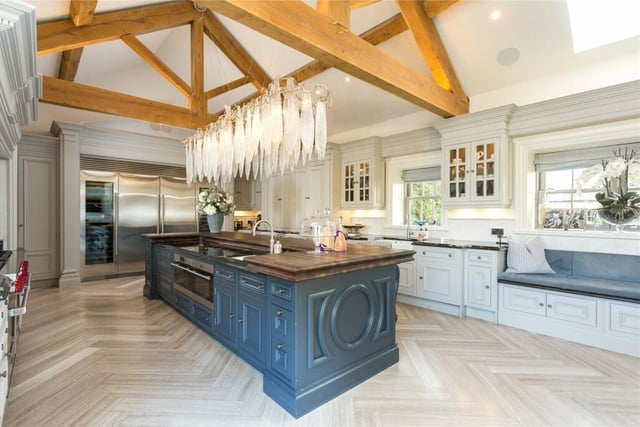 The bespoke Clive Christian kitchen has a range of cupboards in pastel shades, under granite and solid wood worktops, fitted with a range of Sub Zero appliances, a four oven electric wolf oven, separate gas hob, electric oven and Quooker instant boiling water tap.