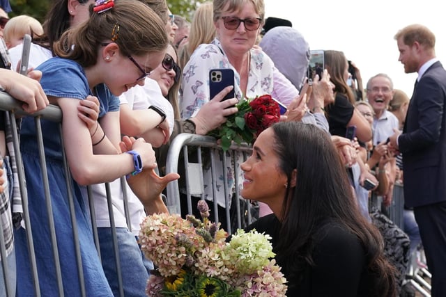 Meghan, Duchess of Sussex meet members of the public at Windsor Castle. Crowds have gathered and tributes left at the gates of Windsor Castle to Queen Elizabeth II. (Photo by Kirsty O'Connor - WPA Pool/Getty Images)