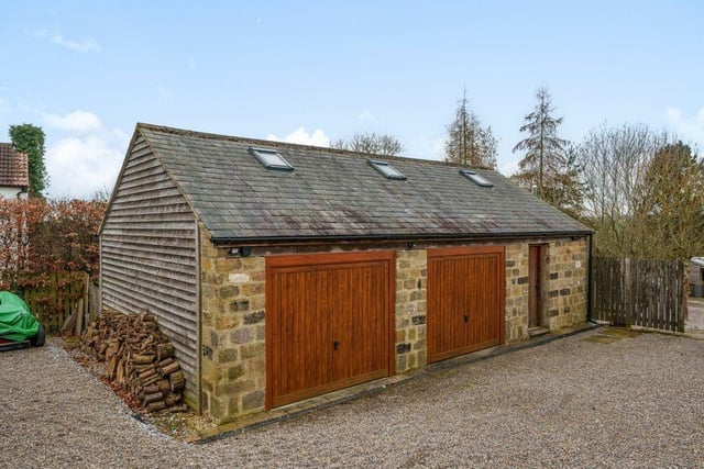 The detached double garage has an adjoining store room.