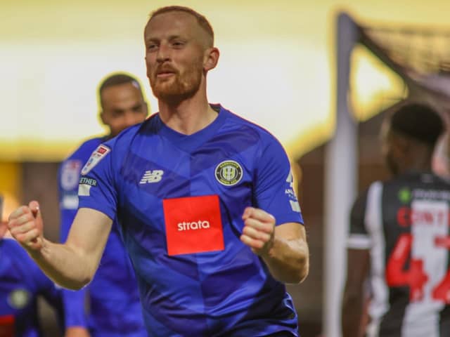 Liam Gibson celebrates after firing Harrogate Town into a 41st-minute lead at Grimsby Town. Picture: Matt Kirkham