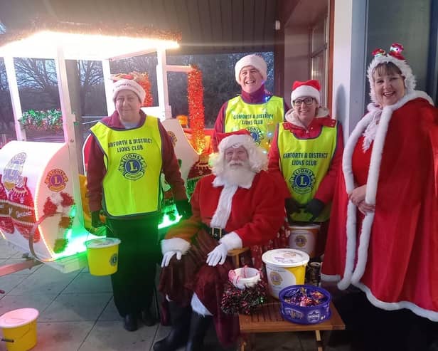 The Lions tour the streets with Santa Claus during their annual fund-raiser.
