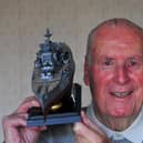 The late Harrogate D Day hero Maurice Hammond pictured with a model of HMS Warspite, the Royal Naval ship he served on in the Second World War.