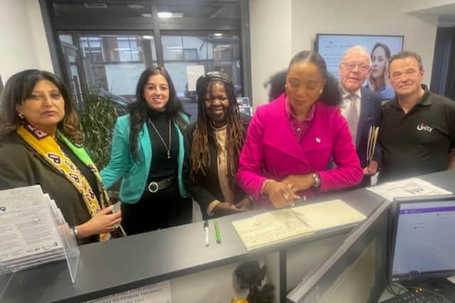 The Lord Mayor of Leeds, Councillor Abigail Marshall Katung (centre) signs the Unity Enterprise guest book watched by (from left to right) Sharon Jandu OBE (chair), Amina Shann (board member), Cristine Wilson (business tenant), John Jagger (board member) and Adrian Green (manager)