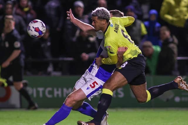 Harrogate Town's Dior Angus competes with Colchester United centre-half Tommy Smith during Saturday's League Two clash at Wetherby Road.