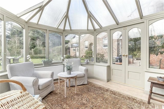 The versatile conservatory has a door out to the gardens.