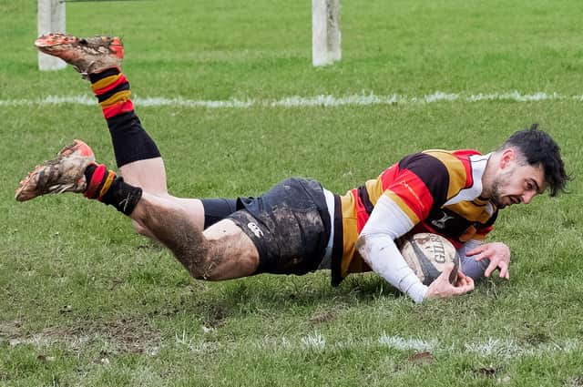 Ben Raubitschek dives over the whitewash to score Harrogate RUFC's first try during Saturday's convincing home victory over Blaydon RFC. Picture: Richard Bown