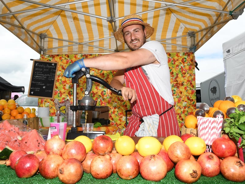 Masal Zone making fresh juice on the Freshly Squeezed Fruits stall at the festival