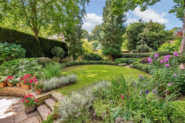 The landscaped rear garden has deep filled borders.