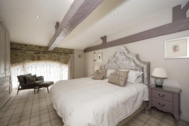 This double bedroom has a stone arch window feature.