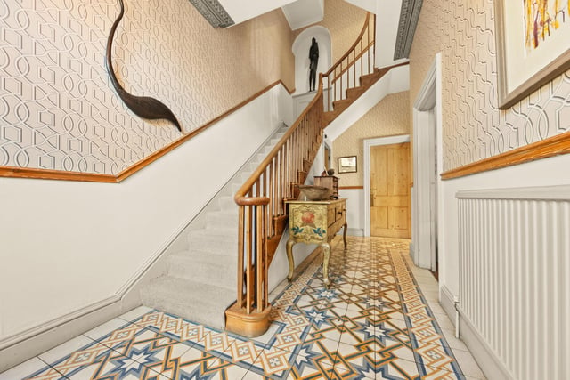 The entrance hallway with staircase up has a tiled floor and period decorative detail.