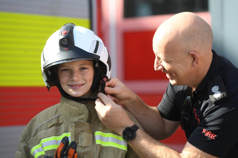 Tom Scott (aged eleven) getting dressed up in a firefighters outfit