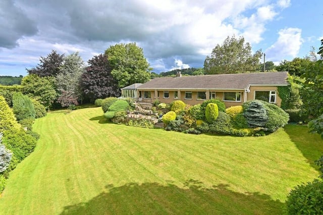 The bungalow's lawned and landscaped gardens are meticulously maintained.
