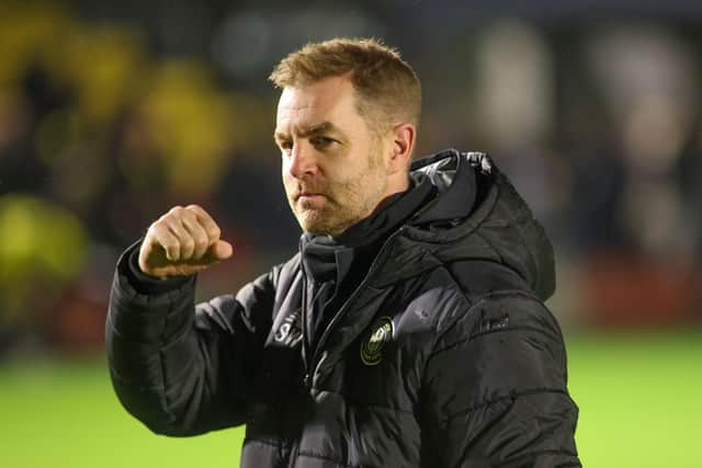 Harrogate Town manager Simon Weaver celebrates his side's 3-0 League Two success over Mansfield Town after the final whistle.