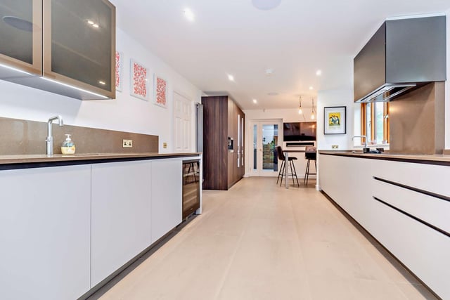 The interior includes a sleek and modern open plan kitchen.