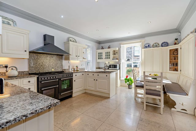The well equipped dining kitchen has corner seating with a granite-topped table.