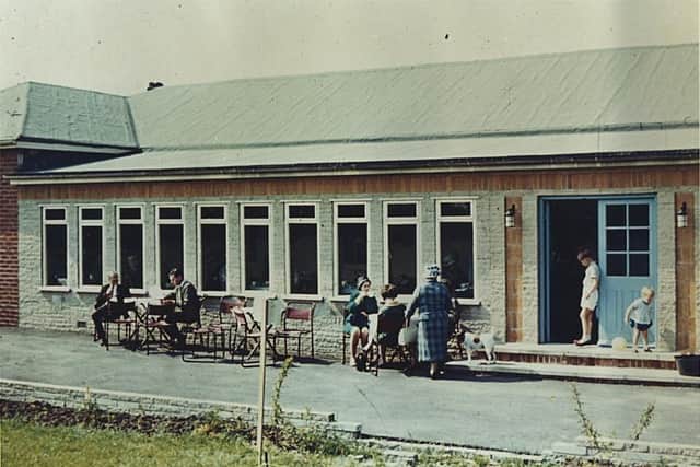 Residents sitting outside the old hall in the sun in 1963