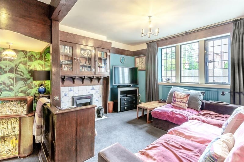 A comfortable snug has a fireplace and built-in cupboards.