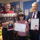 Christmas card design competition - Harrogate and Knaresborough MP Andrew Jones, with Richard Taylor School winning pupil Misha and Richard Taylor headteacher Andrew Symonds