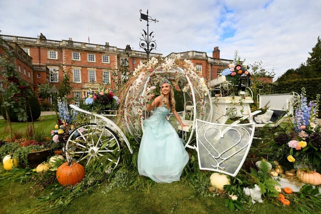 Kathryn Moore dressed as Cinderella in front of the house at Newby Hall