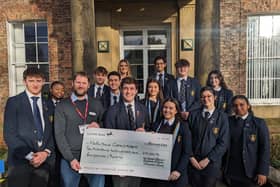 Pictured: Student's handing over the cheque to Martin House regional fundraiser - Duncan Brownnutt, Edward, Eva (centre) and Will (far left).