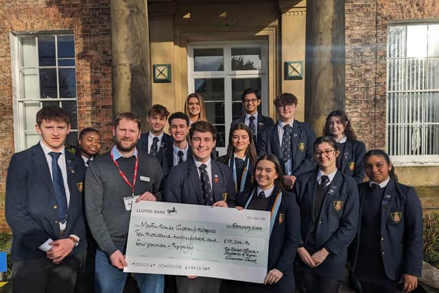 Pictured: Student's handing over the cheque to Martin House regional fundraiser - Duncan Brownnutt, Edward, Eva (centre) and Will (far left).