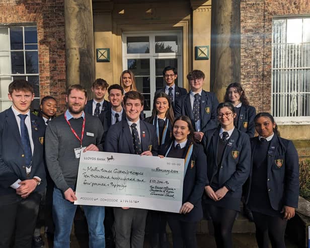 Pictured: Student's handing over the cheque to Martin House regional fundraiser - Duncan Brownnutt, Edward, Eva (centre) and Will (far left).