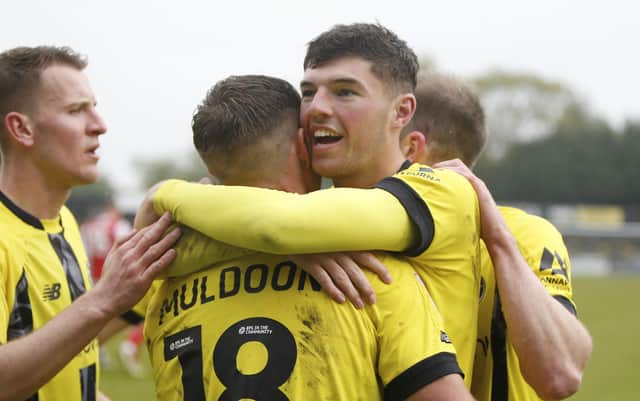Ellis Taylor takes the congratulations of his Harrogate Town team-mates after putting them 2-1 up against Fleetwood. Pictures: Paul Thompson/ProSportsImages