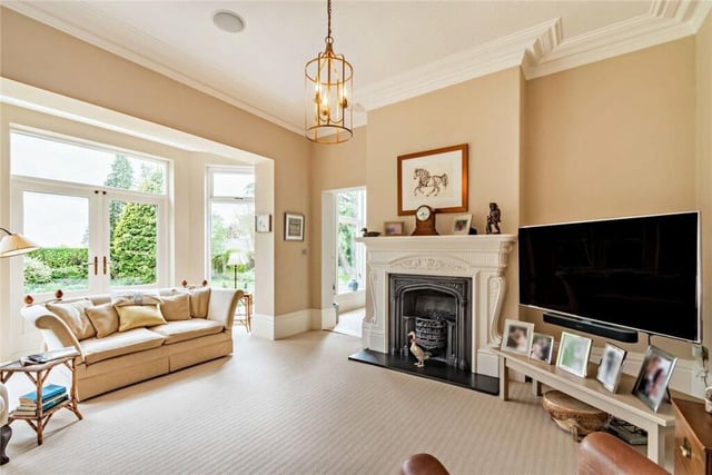 The deep bay window in this reception room has French doors out to the terrace and gardens.