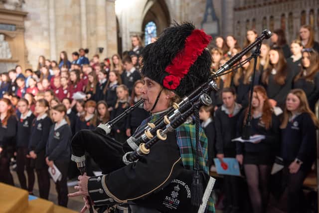 Pictured: Piper Ruth Wright, with the schools’ choirs in the background.