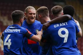 Harrogate Town players celebrate Matty Daly's eighth-minute winner against Bradford City during Saturday's FA Cup first-round clash at Valley Parade. Pictures: Matt Kirkham