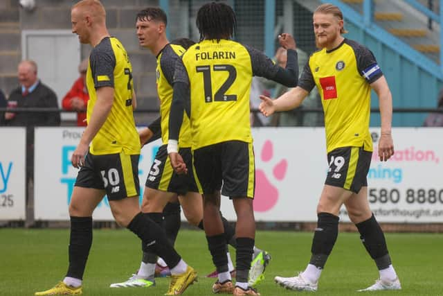 Luke Armstrong, right, is congratulated by Sulphurites team-mate Sam Folarin after completing his hat-trick.