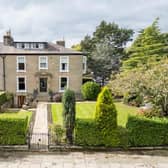 The townhouse has a prominent corner plot with landscaped gardens.