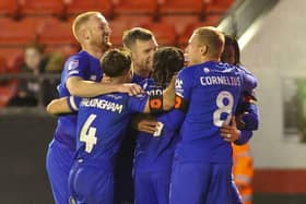 Harrogate Town players celebrate after taking the lead late on in Saturday's League Two clash with Walsall. Pictures: Matt Kirkham