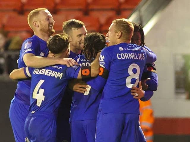 Harrogate Town players celebrate after taking the lead late on in Saturday's League Two clash with Walsall. Pictures: Matt Kirkham