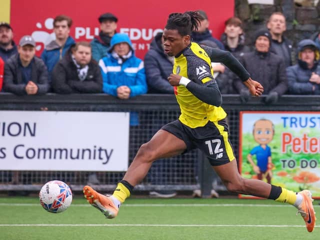 Sam Folarin slots home his first goal during Harrogate Town's FA Cup first-round win at Marine. Pictures: Matt Kirkham