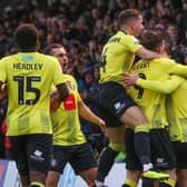 Harrogate Town's players celebrate after Alex Pattison fired them into a fifth-minute lead against Mansfield Town. Pictures: Matt Kirkham