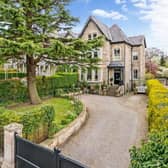 The lovely approach to the property, with gated driveway and lawned front garden.