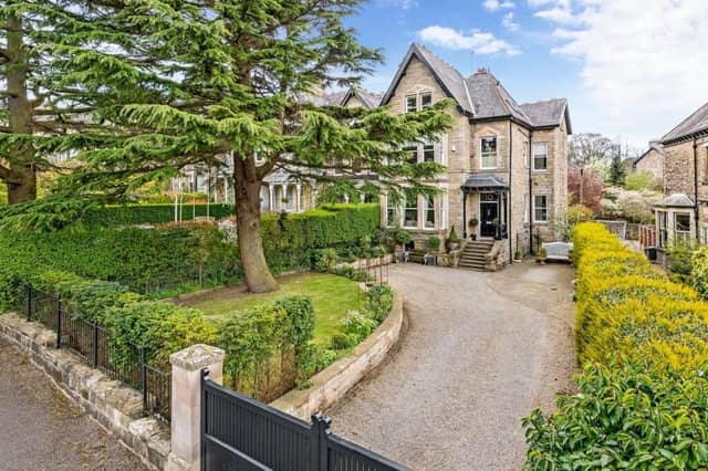 The lovely approach to the property, with gated driveway and lawned front garden.