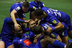 Harrogate Town players celebrate after taking a 3-1 lead during their 2021/22 success over Bradford City at Valley Parade. Pictures: Matt Kirkham